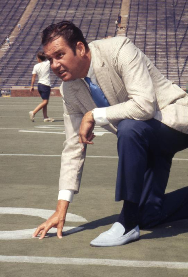 Don Canham inspecting artificial turf at Michigan Stadium, 1969.