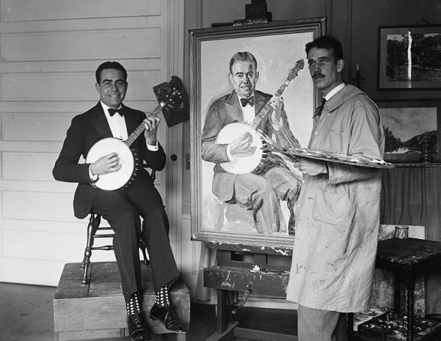 Artist painting man with banjo, c. 1924.